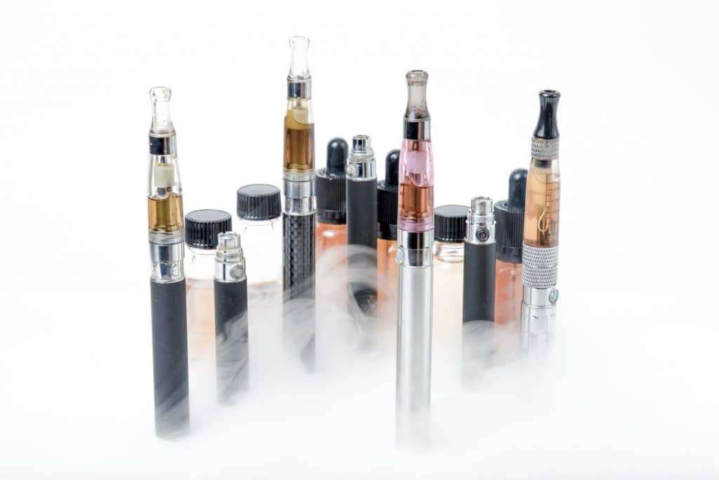 Electronic cigarettes with e-juice bottles with smoke