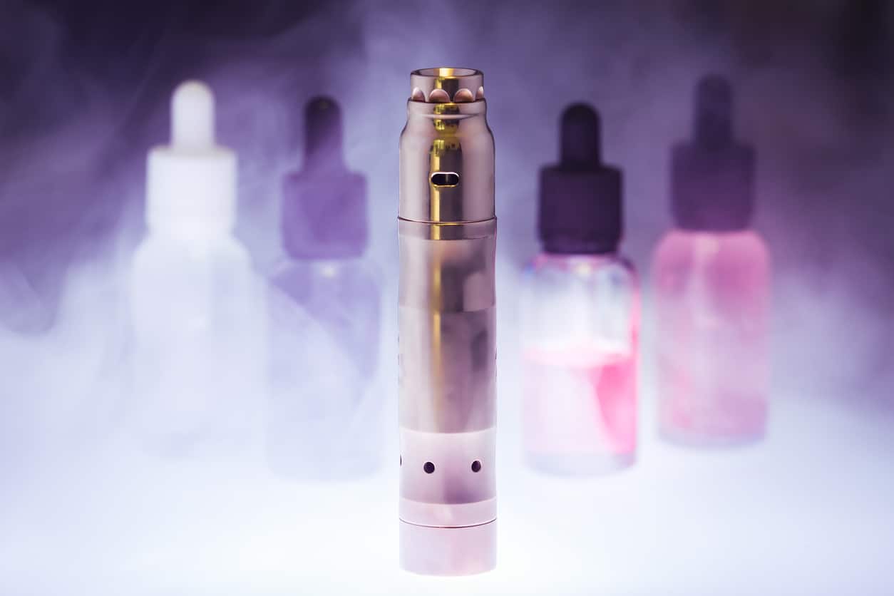 Electronic cigarette with e-liquid in the white smoke