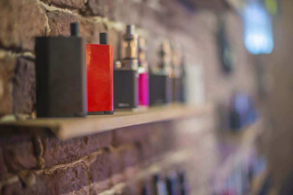 Electronic cigarette on a background of vape shop.
