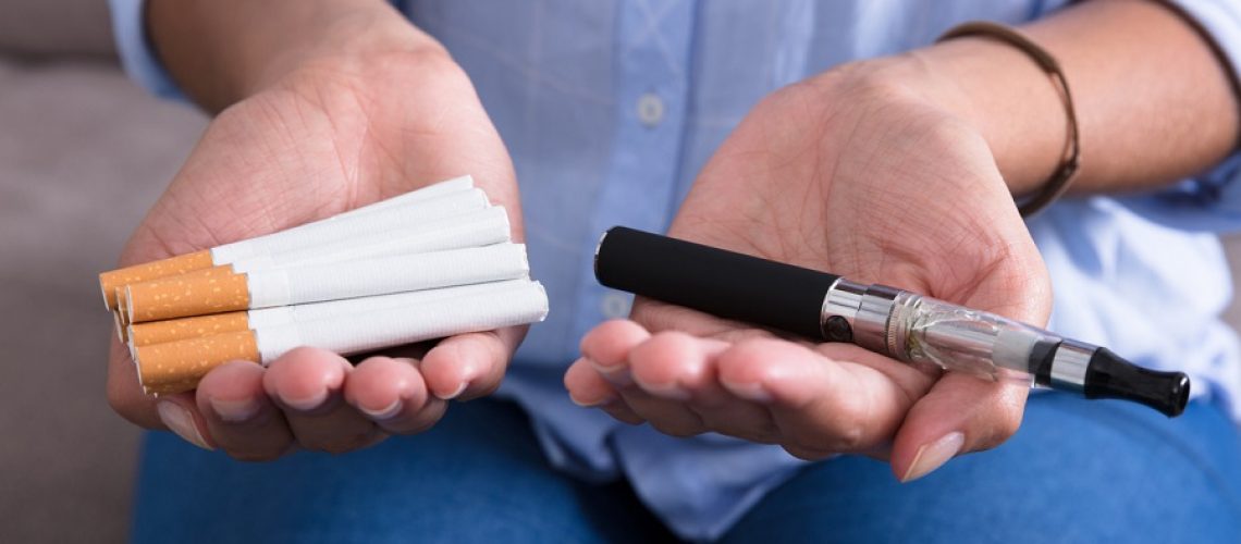 Close-up Of Woman Holding Electronic Cigarette In Hand